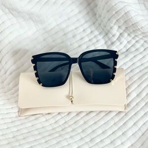 Black and gold oversized sunglasses.